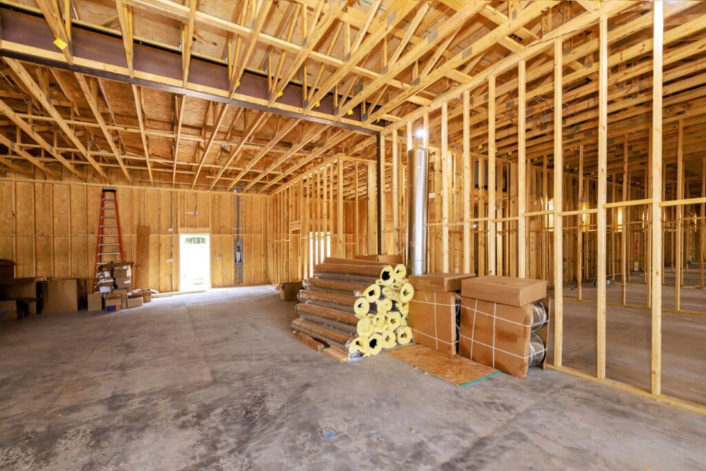 Construction,Underway,With,Wooden,Framing,,Insulation,,Materials,Stacked,Inside,New